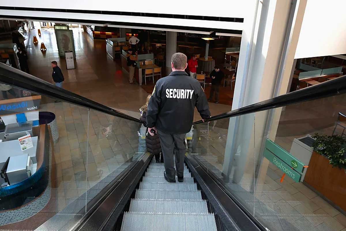 A security officer patrols a bustling shopping center, maintaining a safe and secure environment for shoppers and staff.